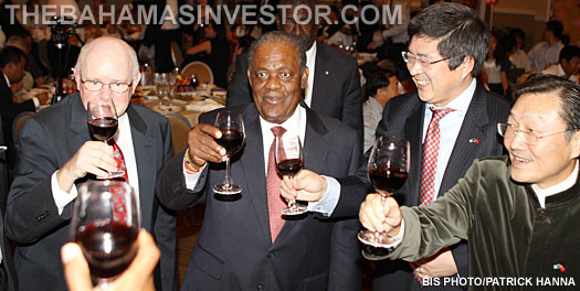 Prime Minister Hubert Ingraham joins in with a toast