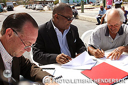 Neko Grant, Minister of Public Works and Transport is pictured at centre signing contracts for upgrades to the dock and construction of public toilets in Clarence Town, Long Island. Also shown left is Colin Higgs, Permanent Secretary, and Laurin Knowles, contractor. (BIS photo/Letisha Henderson)