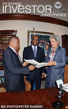 Zhivargo Laing (left) and IDB Bahamas representative Astrid Wynter