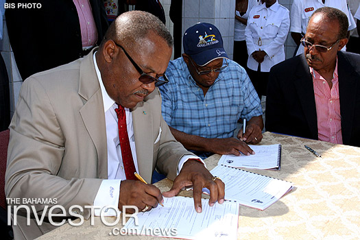 Neko Grant signs the contract