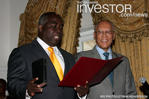 Philip Edward Davis takes the oath during a ceremony in the ballroom at Government House