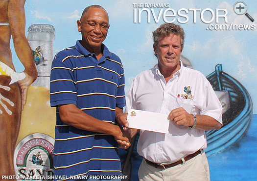 James Sands (left) presents a cheque to Sheldon Gibson