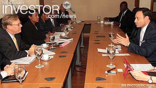 Minister of Financial Services Ryan Pinder (left) listens to Secretary of State Executive Director in the Export and Investment Center