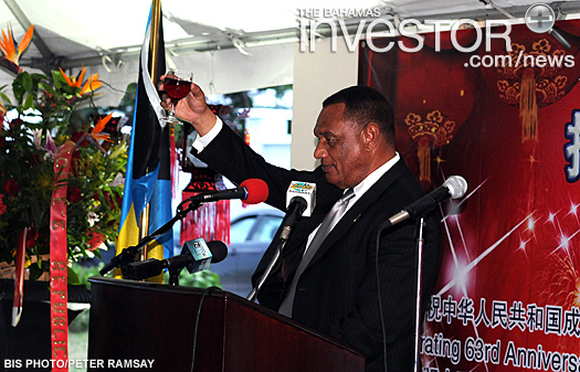 Prime Minister Perry Christie raises his glass